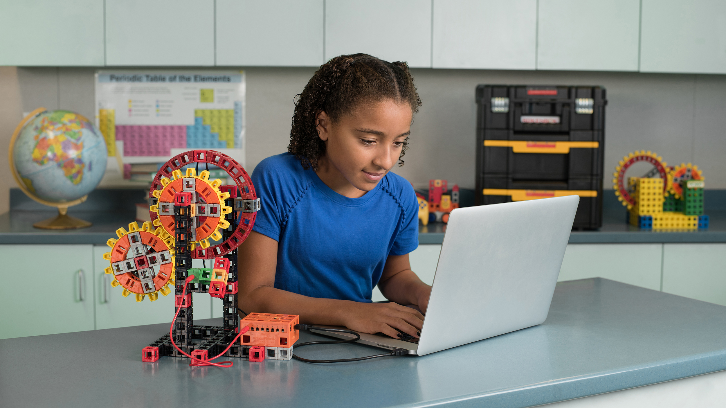 Image of students using a remote to control machines from a STEM kit